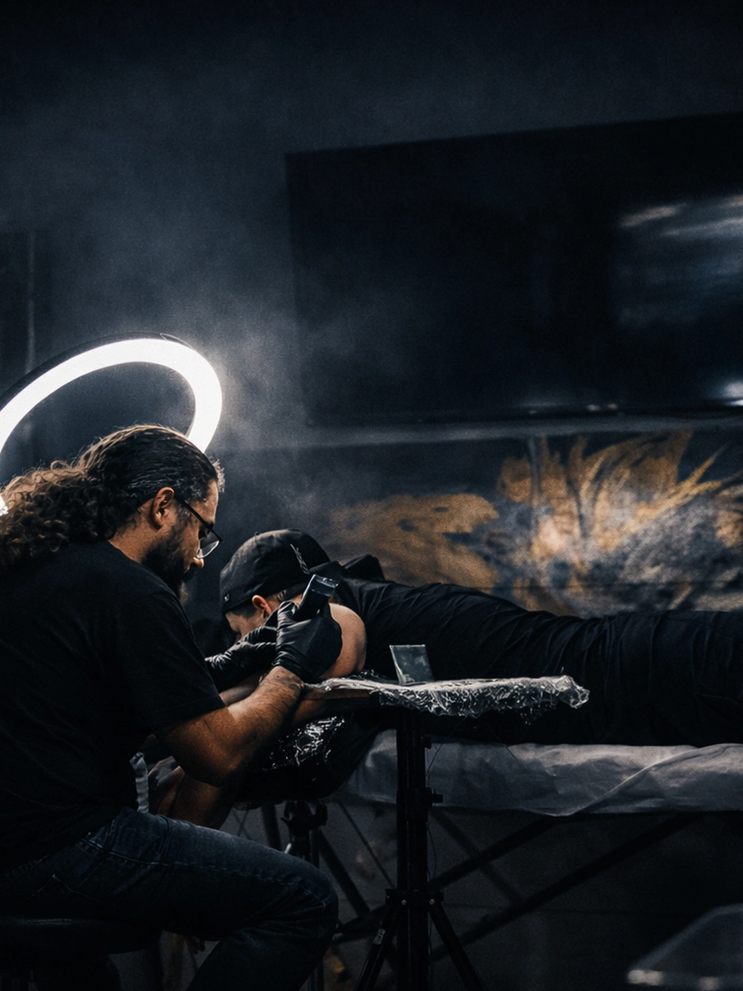 Tattoo artist preparing stencil under cinematic low light