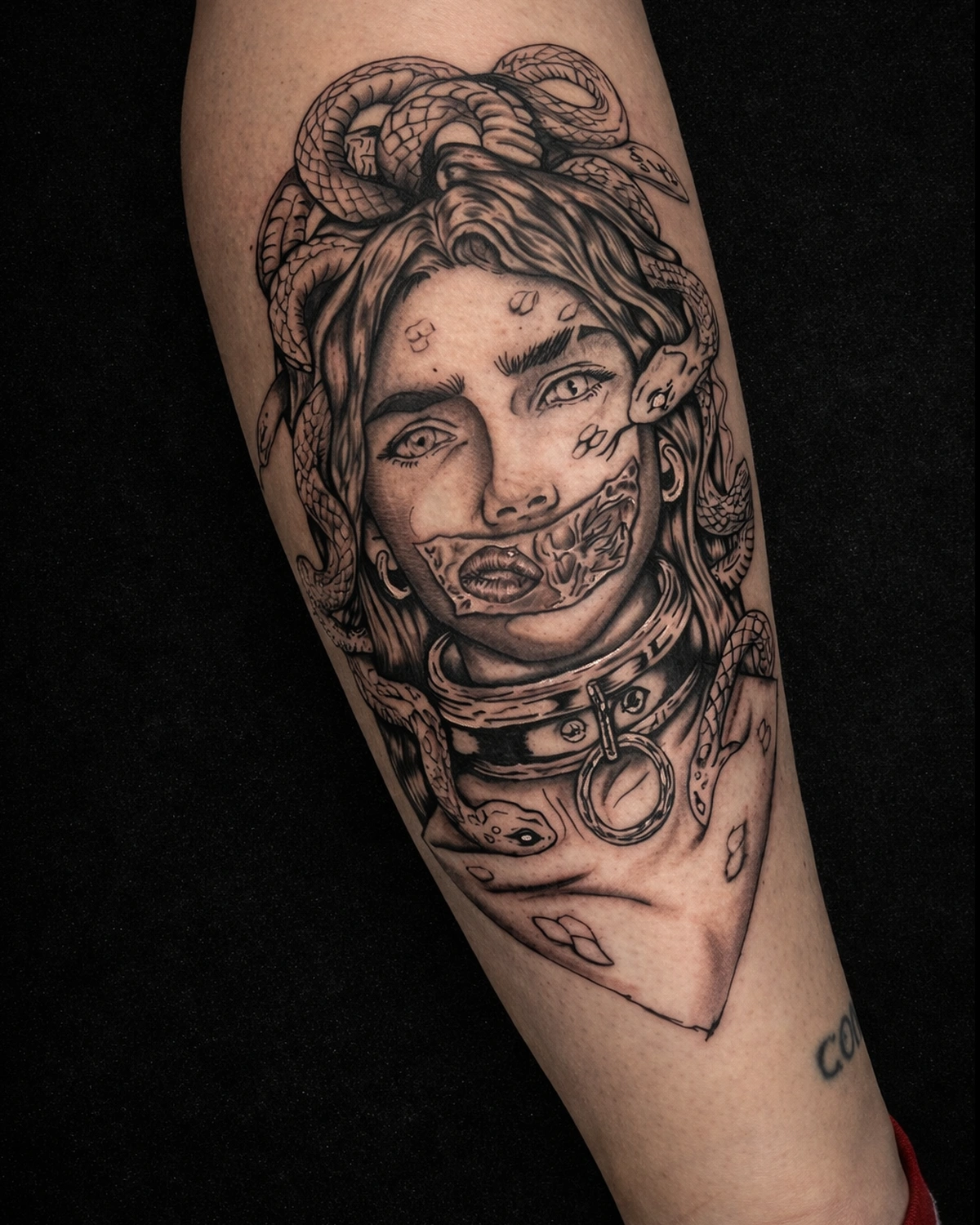 Dark leg tattoo with heavy contrast, texture, and serpent energy