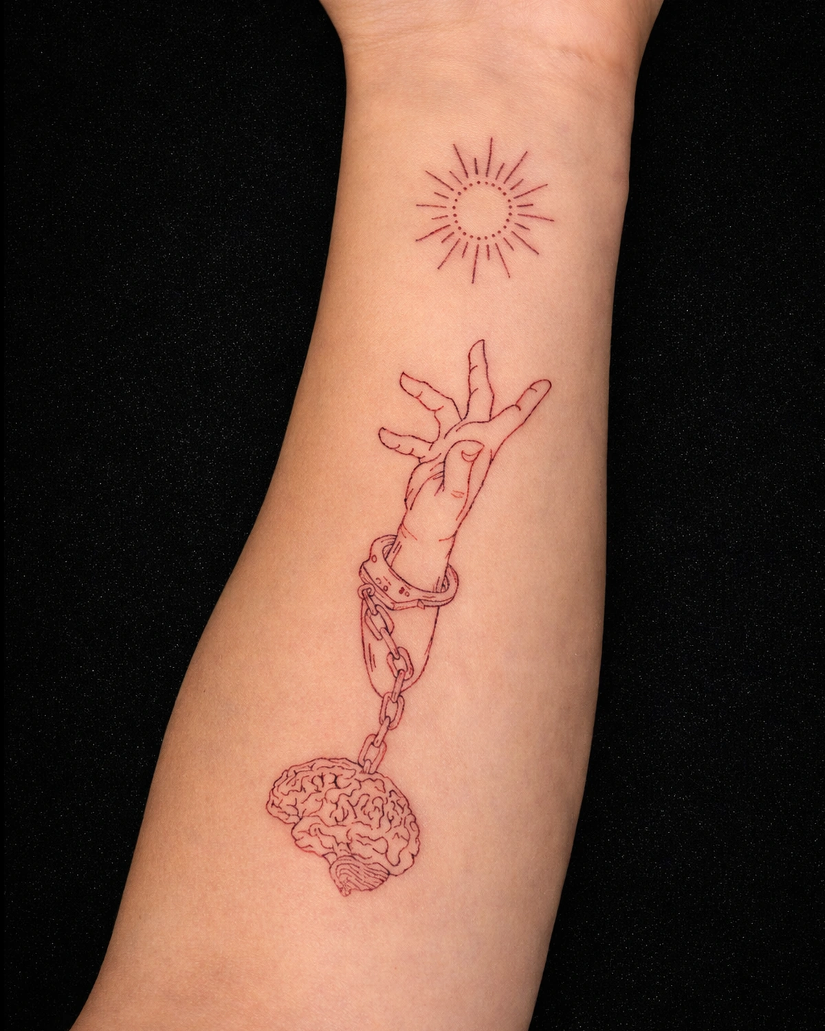 Fine-line red ink forearm tattoo with a surreal minimalist concept
