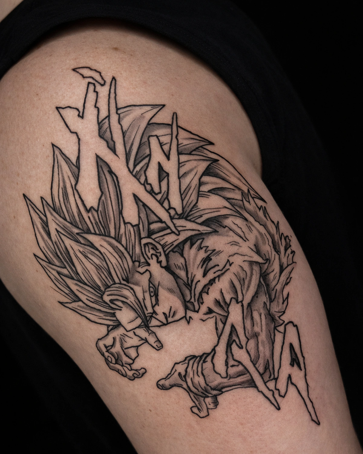 DBZ-inspired anime shoulder tattoo with bold outlines and strong shapes